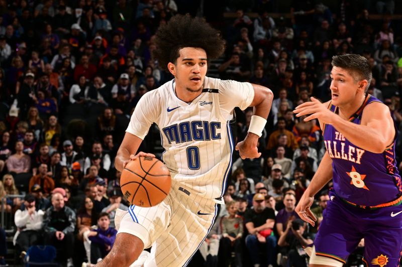 PHOENIX, AZ - NOVEMBER 18: Anthony Black #0 of the Orlando Magic handles the ball during the game against the Phoenix Suns on November 18, 2024 at Footprint Center in Phoenix, Arizona. NOTE TO USER: User expressly acknowledges and agrees that, by downloading and or using this photograph, user is consenting to the terms and conditions of the Getty Images License Agreement. Mandatory Copyright Notice: Copyright 2024 NBAE (Photo by Kate Frese/NBAE via Getty Images)