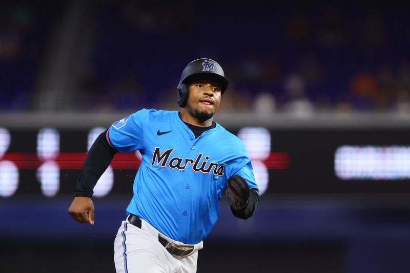 Aug 11, 2024; Miami, Florida, USA; Miami Marlins shortstop Xavier Edwards (63) runs toward this base after after abase hit by third baseman Jake Burger (not pictured) during the first inning at loanDepot Park. Mandatory Credit: Sam Navarro-USA TODAY Sports