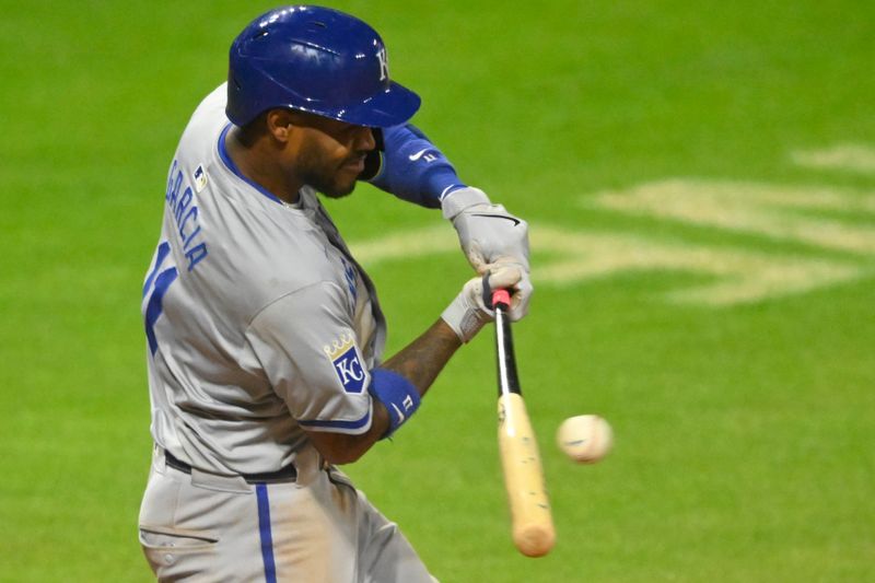 Aug 27, 2024; Cleveland, Ohio, USA; Kansas City Royals second baseman Maikel Garcia (11) hits a RBI single in the seventh inning against the Cleveland Guardians at Progressive Field. Mandatory Credit: David Richard-USA TODAY Sports