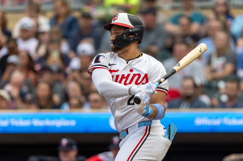 Jun 19, 2024; Minneapolis, Minnesota, USA; Minnesota Twins third baseman Royce Lewis (23) hits a single against the Tampa Bay Rays in the first inning at Target Field. Mandatory Credit: Jesse Johnson-USA TODAY Sports