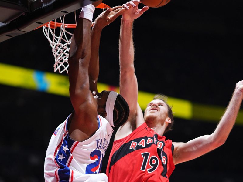 TORONTO, CANADA - OCTOBER 25: Jakob Poeltl #19 of the Toronto Raptors block during the game against the Philadelphia 76ers on October 25, 2024 at the Scotiabank Arena in Toronto, Ontario, Canada.  NOTE TO USER: User expressly acknowledges and agrees that, by downloading and or using this Photograph, user is consenting to the terms and conditions of the Getty Images License Agreement.  Mandatory Copyright Notice: Copyright 2024 NBAE (Photo by Mark Blinch/NBAE via Getty Images)