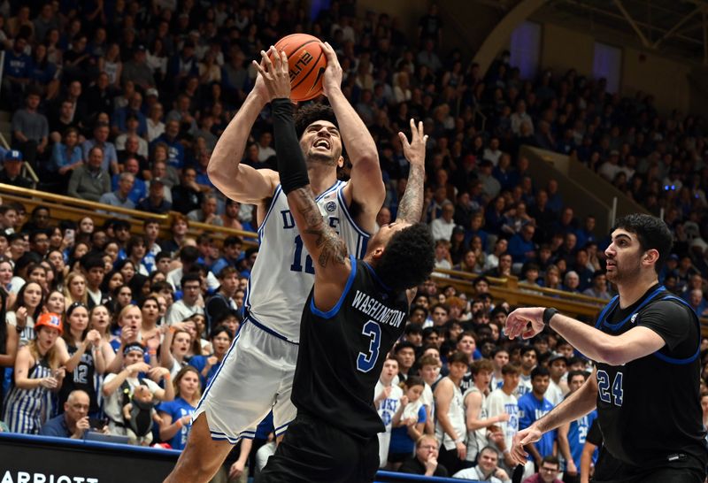 Jan 10, 2026; Durham, North Carolina, USA; Duke Blue Devils forward Cameron Boozer (12) shoots over Southern Methodist Mustangs forward Corey Washington (3) during the second half at Cameron Indoor Stadium. Mandatory Credit: Rob Kinnan-Imagn Images