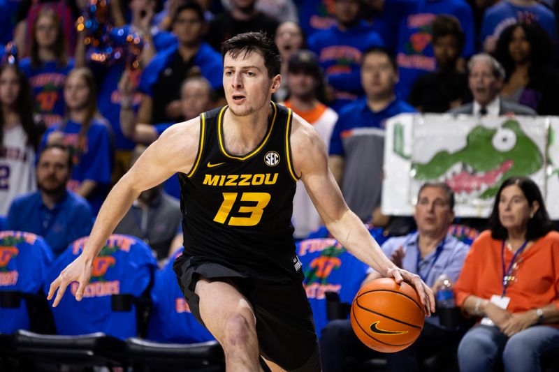 Feb 28, 2024; Gainesville, Florida, USA; Missouri Tigers forward Jesus Carralero Martin (13) drives to the basket against the Florida Gators during the first half at Exactech Arena at the Stephen C. O'Connell Center. Mandatory Credit: Matt Pendleton-USA TODAY Sports