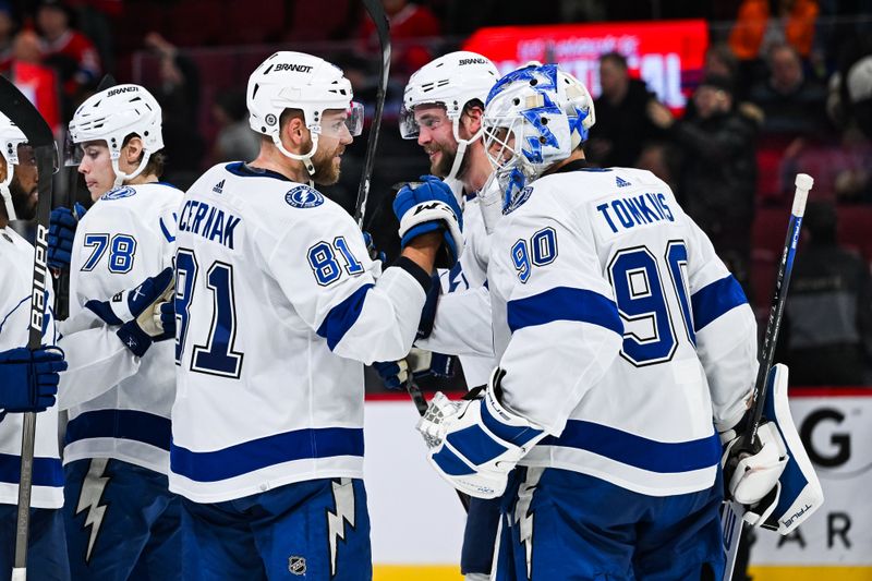 Apr 4, 2024; Montreal, Quebec, CAN; Tampa Bay Lightning defenseman Erik Cernak (81) and goalie Matt Tomkins (90) celebrate the win against the Montreal Canadiens after the end of the game at Bell Centre. Mandatory Credit: David Kirouac-USA TODAY Sports