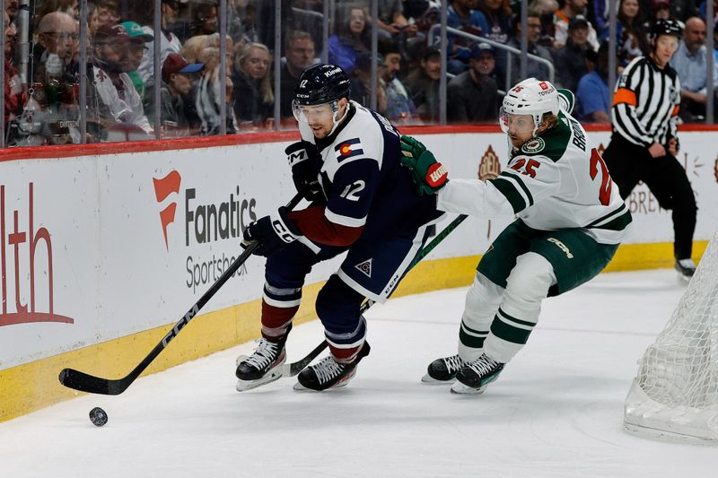 Apr 9, 2024; Denver, Colorado, USA; Colorado Avalanche right wing Brandon Duhaime (12) controls the puck ahead of Minnesota Wild defenseman Jonas Brodin (25) in the second period at Ball Arena. Mandatory Credit: Isaiah J. Downing-USA TODAY Sports