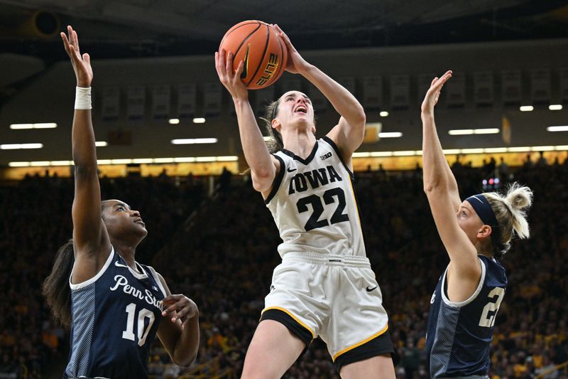 Feb 8, 2024; Iowa City, Iowa, USA; Iowa Hawkeyes guard Caitlin Clark (22) goes to the basket as Penn State Nittany Lions forward Chanaya Pinto (10) and guard Makenna Marisa (20) defend during the second half at Carver-Hawkeye Arena. Mandatory Credit: Jeffrey Becker-USA TODAY Sports