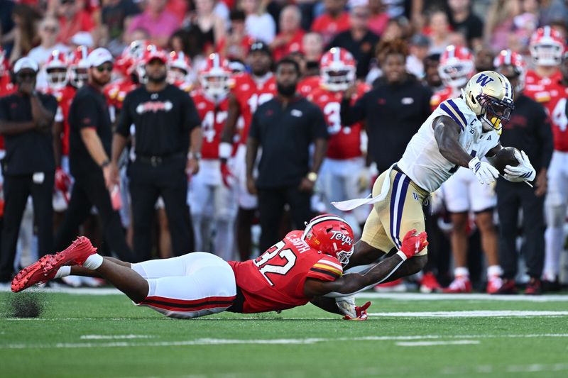 Oct 4, 2025; College Park, Maryland, USA;  Washington Huskies running back Jonah Coleman (1) is tripped up by Maryland Terrapins linebacker Carlton Smith (32) in the second half at SECU Stadium. Mandatory Credit: Jamie Sabau-Imagn Images