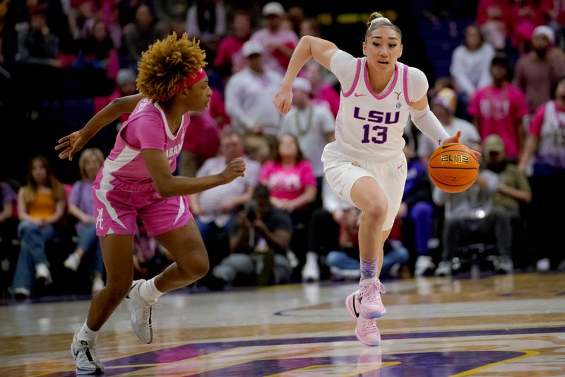 Feb 11, 2024; Baton Rouge, Louisiana, USA; LSU Lady Tigers guard Last-Tear Poa (13) dribbles agaisnt Alabama Crimson Tide guard Loyal McQueen (0) during the second half at Pete Maravich Assembly Center. Mandatory Credit: Matthew Hinton-USA TODAY Sports