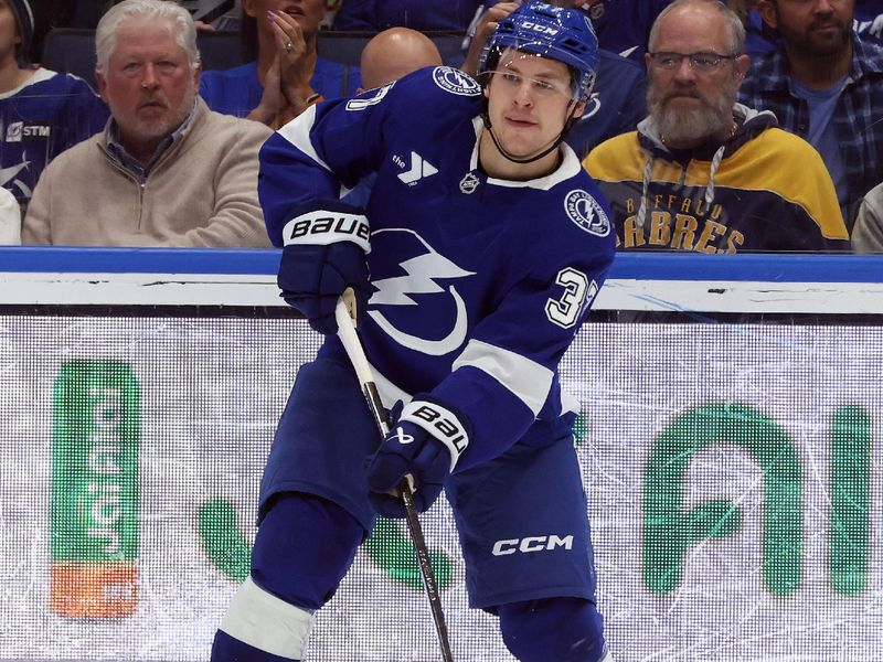 Mar 6, 2025; Tampa, Florida, USA; Tampa Bay Lightning center Yanni Gourde (37) passes the puck against the Buffalo Sabres during the second period at Amalie Arena. Mandatory Credit: Kim Klement Neitzel-Imagn Images