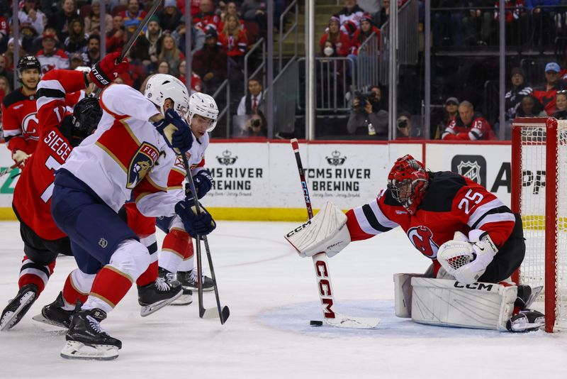 Jan 14, 2025; Newark, New Jersey, USA; New Jersey Devils goaltender Jacob Markstrom (25) makes a save against the Florida Panthers during the third period at Prudential Center. Mandatory Credit: Ed Mulholland-Imagn Images