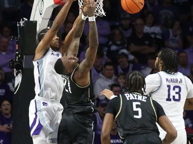 Jan 6, 2024; Manhattan, Kansas, USA; UCF Knights guard C.J. Walker (21) loses the ball as he goes to the basket against Kansas State Wildcats forward David N'Guessan (1) during the first half at Bramlage Coliseum. Mandatory Credit: Scott Sewell-USA TODAY Sports