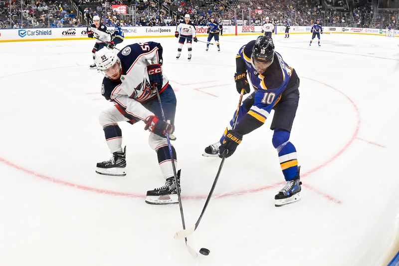 Oct 1, 2024; St. Louis, Missouri, USA;  Columbus Blue Jackets defenseman David Jiricek (55) and St. Louis Blues center Brayden Schenn (10) battle for the puck during the second period at Enterprise Center. Mandatory Credit: Jeff Curry-Imagn Images