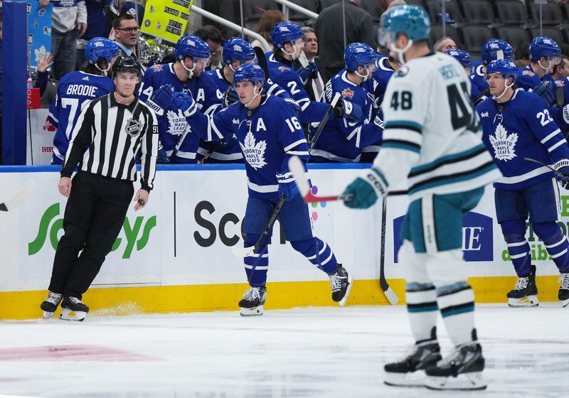 Jan 9, 2024; Toronto, Ontario, CAN; Toronto Maple Leafs right wing Mitchell Marner (16) celebrates at the bench after scoring a goal against the San Jose Sharks during the second period at Scotiabank Arena. Mandatory Credit: Nick Turchiaro-USA TODAY Sports