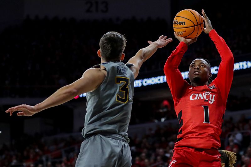 Mar 9, 2024; Cincinnati, Ohio, USA; Cincinnati Bearcats guard Day Day Thomas (1) shoots against West Virginia Mountaineers guard Kerr Kriisa (3) in the first half at Fifth Third Arena. Mandatory Credit: Katie Stratman-USA TODAY Sports