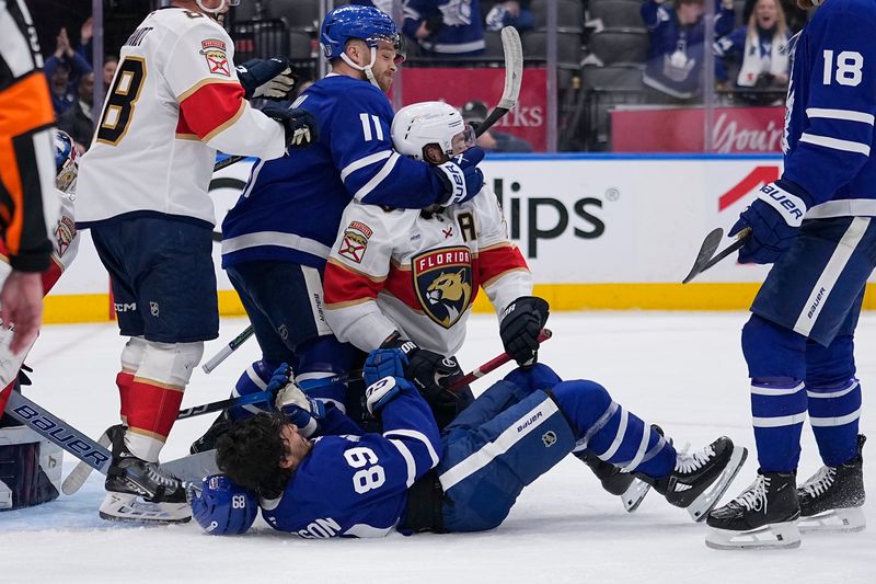 May 14, 2025; Toronto, Ontario, CAN; Toronto Maple Leafs forward Max Domi (11) grabs Florida Panthers defenseman Aaron Ekblad (5) after a goal by Toronto Maple Leafs forward Nicholas Robertson (89) during the third period of game five of the second round of the 2025 Stanley Cup Playoffs at Scotiabank Arena. Mandatory Credit: John E. Sokolowski-Imagn Images