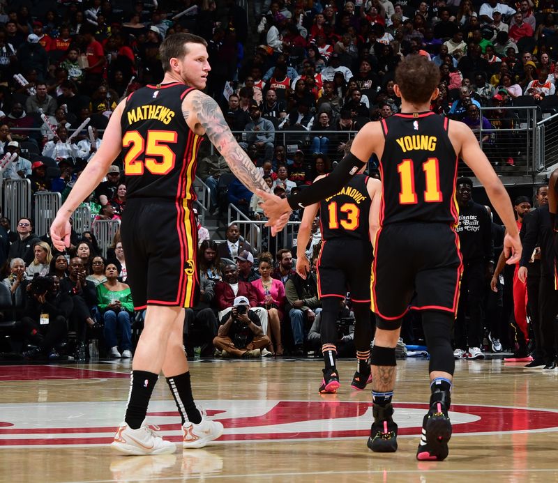 ATLANTA, GA - February 23:   Trae Young #11 and Garrison Mathews #25 of the Atlanta Hawks celebrate during the game against the Toronto Raptors on February 23, 2024 at State Farm Arena in Atlanta, Georgia.  NOTE TO USER: User expressly acknowledges and agrees that, by downloading and/or using this Photograph, user is consenting to the terms and conditions of the Getty Images License Agreement. Mandatory Copyright Notice: Copyright 2024 NBAE (Photo by Scott Cunningham/NBAE via Getty Images)