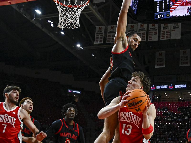 Feb 5, 2026; College Park, Maryland, USA;  Maryland Terrapins center Collin Metcalf (45) defends thew rim as Ohio State Buckeyes center Christoph Tilly (13) looks top shoot during the first half at Xfinity Center. Mandatory Credit: Tommy Gilligan-Imagn Images