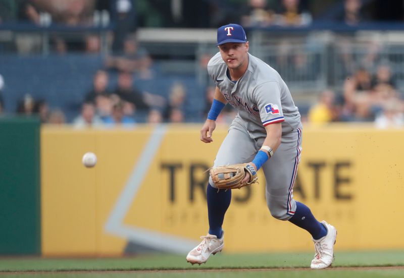 May 22, 2023; Pittsburgh, Pennsylvania, USA;  Texas Rangers third baseman Josh Jung (6) fields a ground ball for an out against Pittsburgh Pirates designated hitter Andrew McCutchen (not pictured) during the fifth inning at PNC Park. Mandatory Credit: Charles LeClaire-USA TODAY Sports