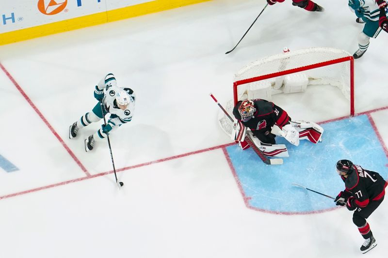 Oct 27, 2023; Raleigh, North Carolina, USA; San Jose Sharks center William Eklund (72) comes out inferno not Carolina Hurricanes goaltender Antti Raanta (32) during the second period at PNC Arena. Mandatory Credit: James Guillory-USA TODAY Sports