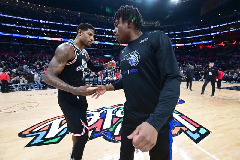 LOS ANGELES, CA - MARCH 18: Paul George #13 of the LA Clippers shakes hands with Admiral Schofield #25 of the Orlando Magic after the game on March 18, 2023 at Crypto.Com Arena in Los Angeles, California. NOTE TO USER: User expressly acknowledges and agrees that, by downloading and/or using this Photograph, user is consenting to the terms and conditions of the Getty Images License Agreement. Mandatory Copyright Notice: Copyright 2023 NBAE (Photo by Adam Pantozzi/NBAE via Getty Images)