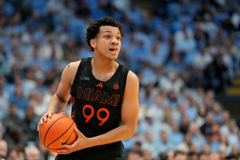 Mar 1, 2025; Chapel Hill, North Carolina, USA;  Miami (Fl) Hurricanes guard Divine Ugochukwu (99) with the ball in the first half at Dean E. Smith Center. Mandatory Credit: Bob Donnan-Imagn Images