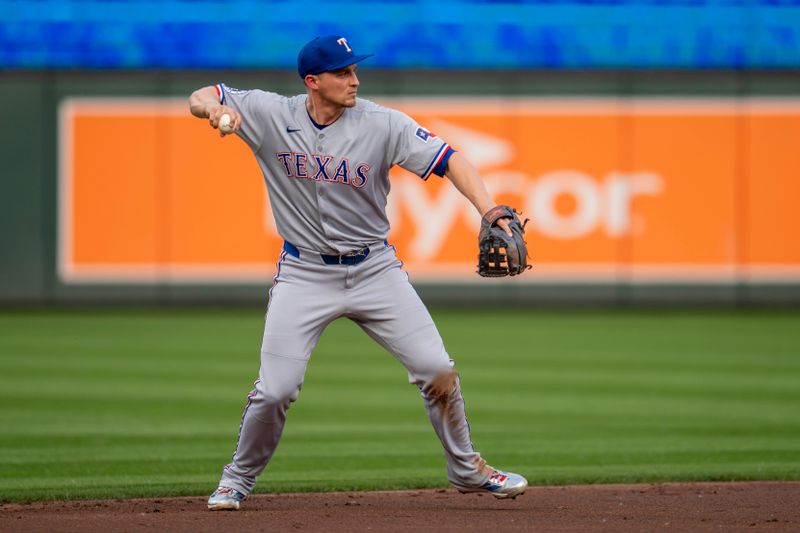 Jun 10, 2025; Minneapolis, Minnesota, USA; Texas Rangers shortstop Corey Seager (5) throws the ball to first base for an out against the Minnesota Twins in the second inning at Target Field. Mandatory Credit: Jesse Johnson-Imagn Images