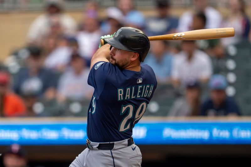Jun 24, 2025; Minneapolis, Minnesota, USA; Seattle Mariners catcher Cal Raleigh (29) hits a double against the Minnesota Twins in the first inning at Target Field. Mandatory Credit: Jesse Johnson-Imagn Images