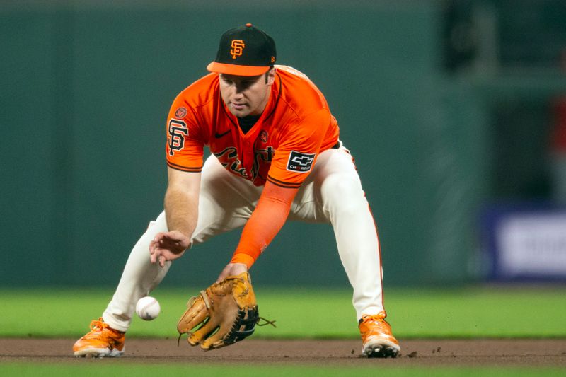 Sep 27, 2024; San Francisco, California, USA; San Francisco Giants designated hitter Casey Schmitt (10) fields a ground ball by St. Louis Cardinals designated hitter Matt Carpenter during the seventh inning at Oracle Park. Mandatory Credit: D. Ross Cameron-Imagn Images