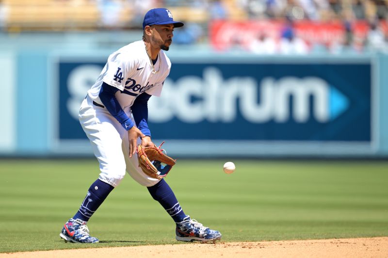 Apr 17, 2024; Los Angeles, California, USA; Los Angeles Dodgers shortstop Mookie Betts (50) fields a ball and throws Washington Nationals third base Nick Senzel (13) out at first in the sixth inning at Dodger Stadium. Mandatory Credit: Jayne Kamin-Oncea-USA TODAY Sports