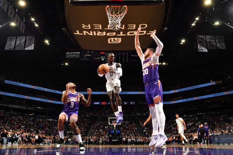 PHOENIX, AZ - NOVEMBER 27: Dennis Schroder #17 of the Brooklyn Nets looks to pass the ball during the game against the Phoenix Suns on November 27, 2024 at Footprint Center in Phoenix, Arizona. NOTE TO USER: User expressly acknowledges and agrees that, by downloading and or using this photograph, user is consenting to the terms and conditions of the Getty Images License Agreement. Mandatory Copyright Notice: Copyright 2024 NBAE (Photo by Barry Gossage/NBAE via Getty Images)