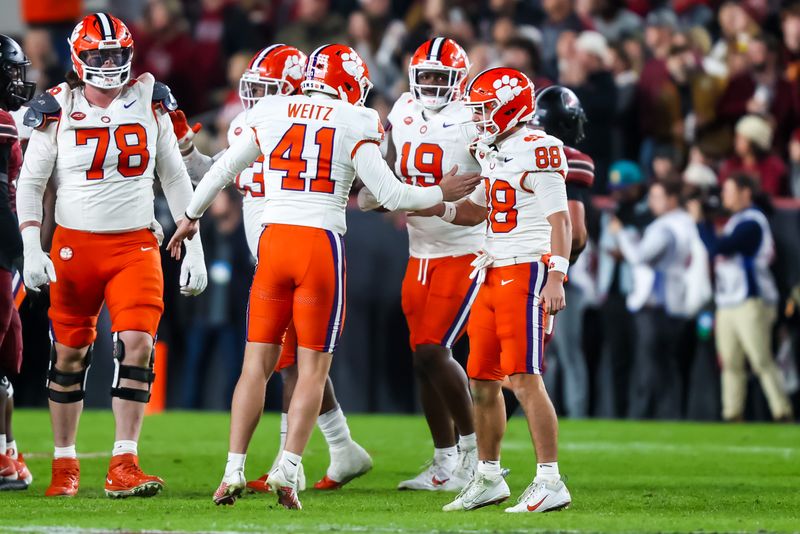 Nov 25, 2023; Columbia, South Carolina, USA; Clemson Tigers place kicker Jonathan Weitz (41) and holder Clay Swinney (88) celebrate after a Weitz field goal by Weitz against the South Carolina Gamecocks in the first quarter at Williams-Brice Stadium. Mandatory Credit: Jeff Blake-USA TODAY Sports