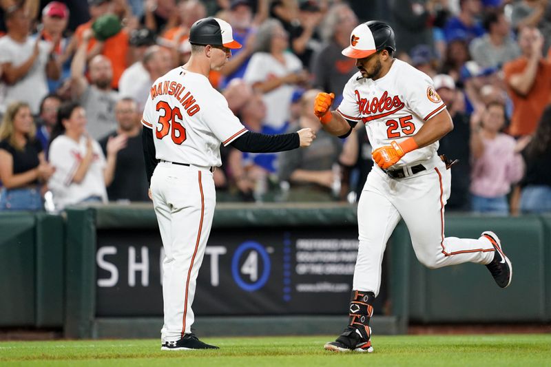 Aug 24, 2023; Baltimore, Maryland, USA; Baltimore Orioles outfielder Anthony Santander (25) greeted by coach Tony Mansolino (36) following his two run home run in the fourth inning against the Toronto Blue Jays at Oriole Park at Camden Yards. Mandatory Credit: Mitch Stringer-USA TODAY Sports