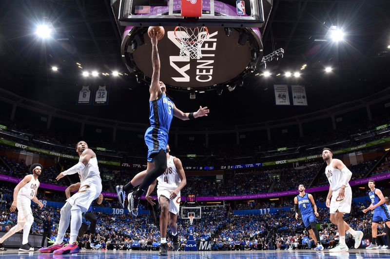 ORLANDO, FL - APRIL 27: Paolo Banchero #5 of the Orlando Magic drives to the basket during the game against the Cleveland Cavaliers during Round 1 Game 4 of the 2024 NBA Playoffs on April 27, 2024 at the Kia Center in Orlando, Florida. NOTE TO USER: User expressly acknowledges and agrees that, by downloading and or using this photograph, User is consenting to the terms and conditions of the Getty Images License Agreement. Mandatory Copyright Notice: Copyright 2024 NBAE (Photo by Fernando Medina/NBAE via Getty Images)