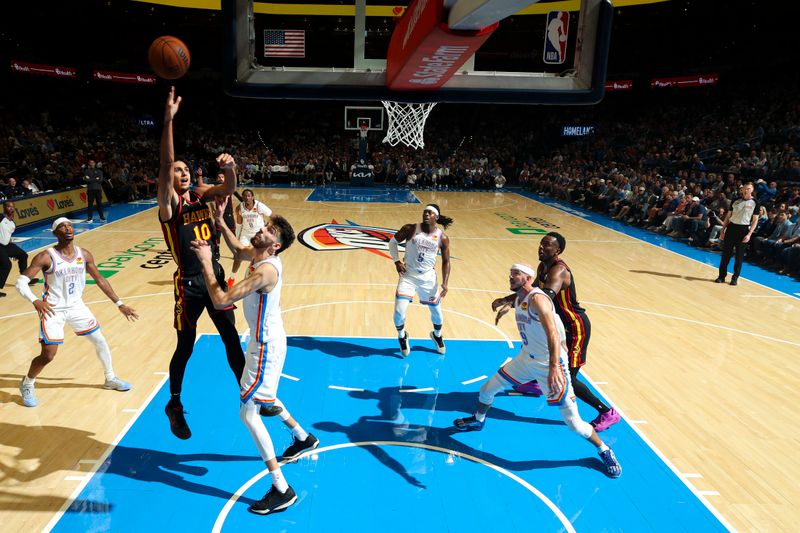 OKLAHOMA CITY, OK - OCTOBER 27: Zaccharie Risacher #10 of the Atlanta Hawks shoots the ball during the game  on October 27, 2024 at Paycom Center in Oklahoma City, Oklahoma. NOTE TO USER: User expressly acknowledges and agrees that, by downloading and or using this photograph, User is consenting to the terms and conditions of the Getty Images License Agreement. Mandatory Copyright Notice: Copyright 2024 NBAE (Photo by Zach Beeker/NBAE via Getty Images)