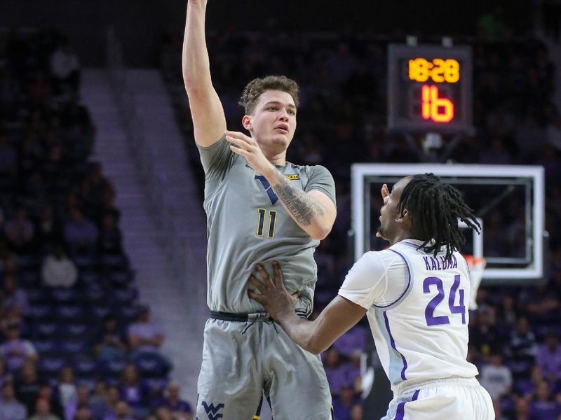 Feb 26, 2024; Manhattan, Kansas, USA; West Virginia Mountaineers forward Quinn Slazinski (11) passes the ball over Kansas State Wildcats forward Arthur Maluma (24) during the second half at Bramlage Coliseum. Mandatory Credit: Scott Sewell-USA TODAY Sports