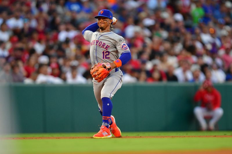 August 3, 2024; Anaheim, California, USA; New York Mets shortstop Francisco Lindor (12) throws to first for the out against Los Angeles Angels right fielder Jo Adell (7) during the fourth inning at Angel Stadium. Mandatory Credit: Gary A. Vasquez-USA TODAY Sports