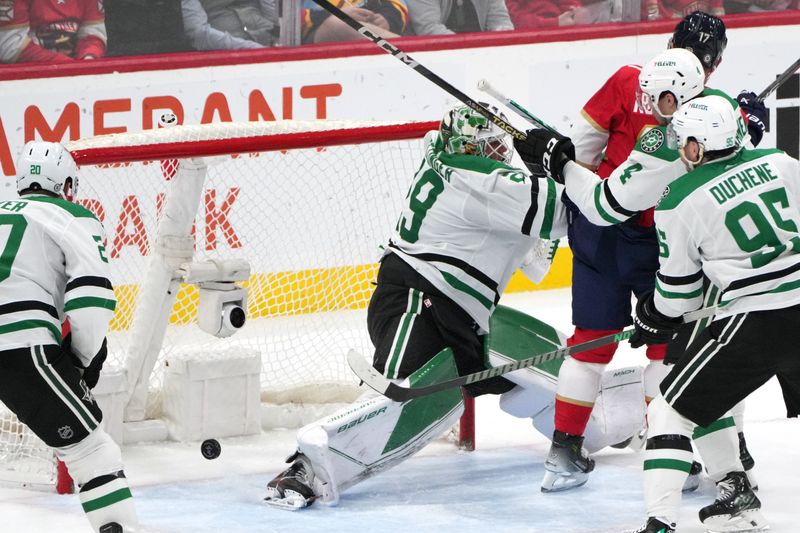 Dec 6, 2023; Sunrise, Florida, USA; Dallas Stars goaltender Jake Oettinger (29) holds off Florida Panthers center Evan Rodrigues (17) as the puck rolls away during the third period at Amerant Bank Arena. Mandatory Credit: Jim Rassol-USA TODAY Sports