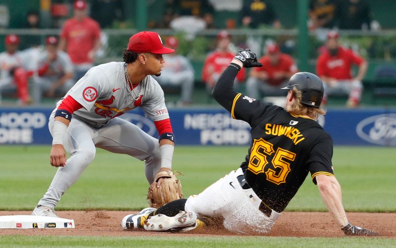 Jul 23, 2024; Pittsburgh, Pennsylvania, USA;  Pittsburgh Pirates center fielder Jack Suwinski (65) arrives safely at second base with a double as St. Louis Cardinals shortstop Masyn Winn (0) takes a throw during the fifth inning at PNC Park. Mandatory Credit: Charles LeClaire-USA TODAY Sports