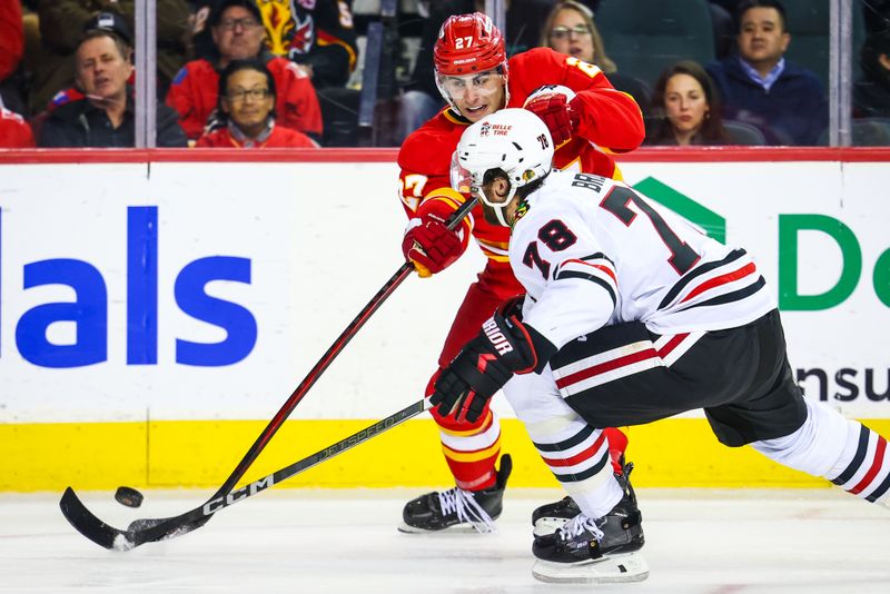 Oct 15, 2024; Calgary, Alberta, CAN; Calgary Flames right wing Matt Coronato (27) shoots the puck against Chicago Blackhawks defenseman TJ Brodie (78) during the second period at Scotiabank Saddledome. Mandatory Credit: Sergei Belski-Imagn Images