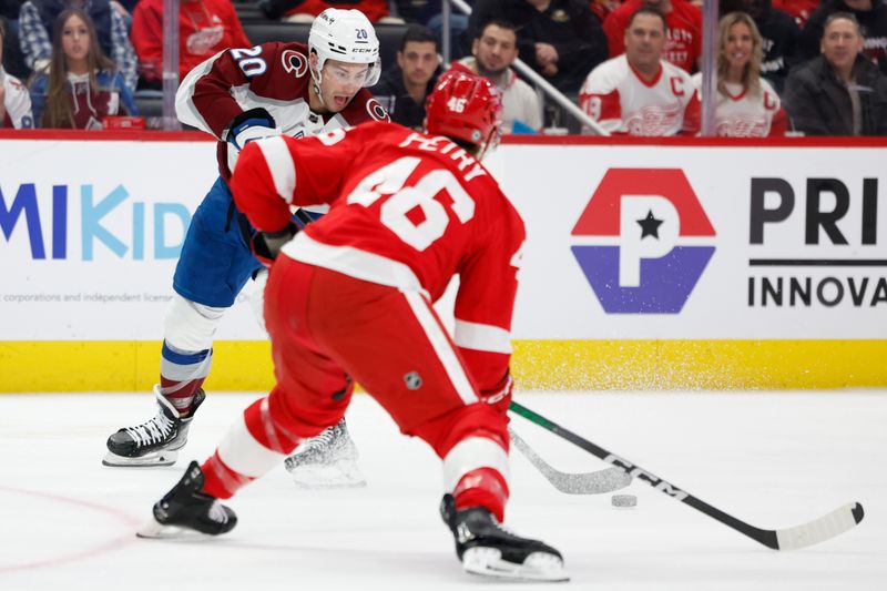 Feb 22, 2024; Detroit, Michigan, USA; Colorado Avalanche center Ross Colton (20) skates with the puck defended by Detroit Red Wings defenseman Jeff Petry (46) in the first period at Little Caesars Arena. Mandatory Credit: Rick Osentoski-USA TODAY Sports