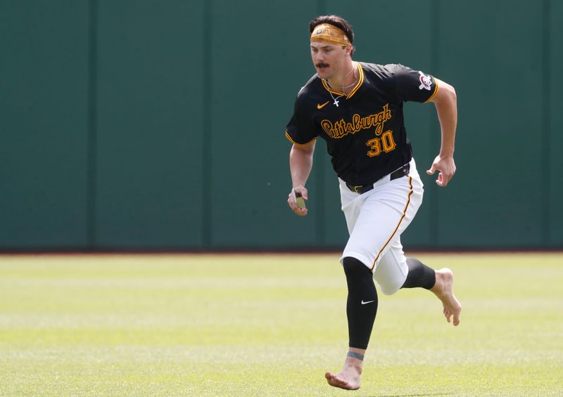 May 26, 2024; Pittsburgh, Pennsylvania, USA;  Pittsburgh Pirates pitcher Paul Skenes (30) runs in the outfield before the game against the Atlanta Braves at PNC Park. Mandatory Credit: Charles LeClaire-USA TODAY Sports