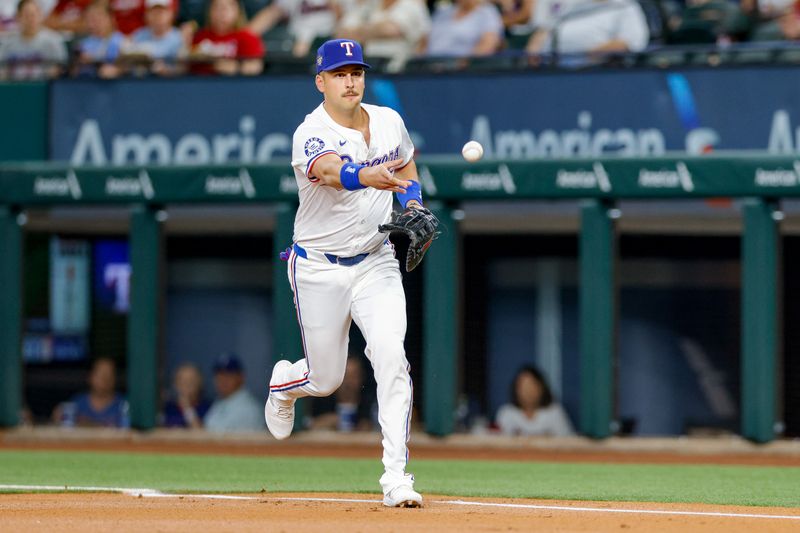 May 15, 2024; Arlington, Texas, USA; Texas Rangers first base Nathaniel Lowe (30) tosses the ball during the first inning against the Cleveland Guardians at Globe Life Field. Mandatory Credit: Andrew Dieb-USA TODAY Sports