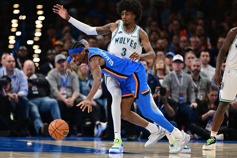 OKLAHOMA CITY, OKLAHOMA - JANUARY 29: Shai Gilgeous-Alexander #2 of the Oklahoma City Thunder loses the ball as he tries to go around Jaden McDaniels #3 of the Minnesota Timberwolves during the second half at Paycom Center on January 29, 2024 in Oklahoma City, Oklahoma. NOTE TO USER: User expressly acknowledges and agrees that, by downloading and or using this Photograph, user is consenting to the terms and conditions of the Getty Images License Agreement. (Photo by Joshua Gateley/Getty Images)