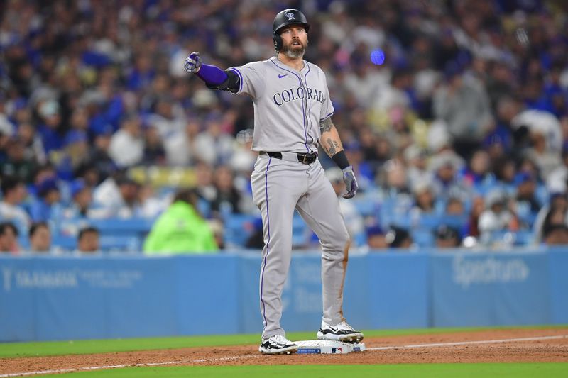 May 31, 2024; Los Angeles, California, USA; Colorado Rockies left fielder Jake Cave (11) reaches third on a triple against the Los Angeles Dodgers during the ninth inning at Dodger Stadium. Mandatory Credit: Gary A. Vasquez-USA TODAY Sports