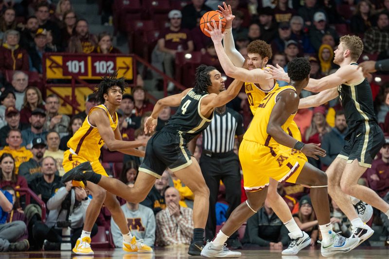 Jan 19, 2023; Minneapolis, Minnesota, USA; Minnesota Golden Gophers forward Jamison Battle (10) rebounds over Purdue Boilermakers forward Trey Kaufman-Renn (4) in the first half at Williams Arena. Mandatory Credit: Matt Blewett-USA TODAY Sports