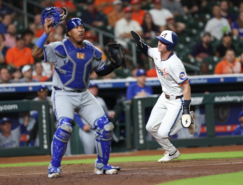 May 12, 2025; Houston, Texas, USA; Houston Astros left fielder Zach Dezenzo (9) scores infant of Kansas City Royals catcher Salvador Perez (13) in the seventh inning at Daikin Park. Mandatory Credit: Thomas Shea-Imagn Images