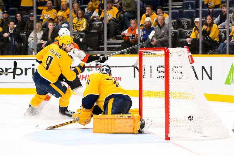 Nov 27, 2024; Nashville, Tennessee, USA;  Philadelphia Flyers center Sean Couturier (14) scores the winning goal against Nashville Predators goaltender Juuse Saros (74) during the the overtime period at Bridgestone Arena. Mandatory Credit: Steve Roberts-Imagn Images