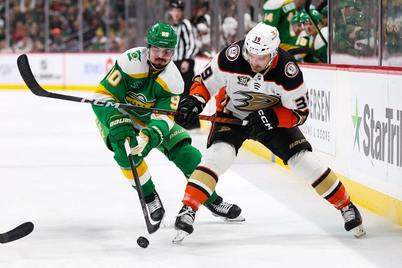 Jan 27, 2024; Saint Paul, Minnesota, USA; Minnesota Wild left wing Marcus Johansson (90) and Anaheim Ducks center Sam Carrick (39) compete for the puck during the first period at Xcel Energy Center. Mandatory Credit: Matt Krohn-USA TODAY Sports