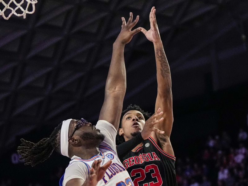 Feb 28, 2023; Athens, Georgia, USA; Georgia Bulldogs center Braelen Bridges (23) shoots over Florida Gators center Jason Jitoboh (33) during the second half at Stegeman Coliseum. Mandatory Credit: Dale Zanine-USA TODAY Sports