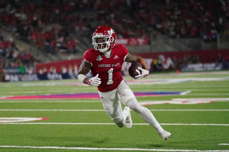 Oct 15, 2022; Fresno, California, USA; Fresno State Bulldogs wide receiver Nikko Remigio (1) scores a touchdown against the San Jose State Spartans in the third quarter at Valley Children's Stadium. Mandatory Credit: Cary Edmondson-USA TODAY Sports